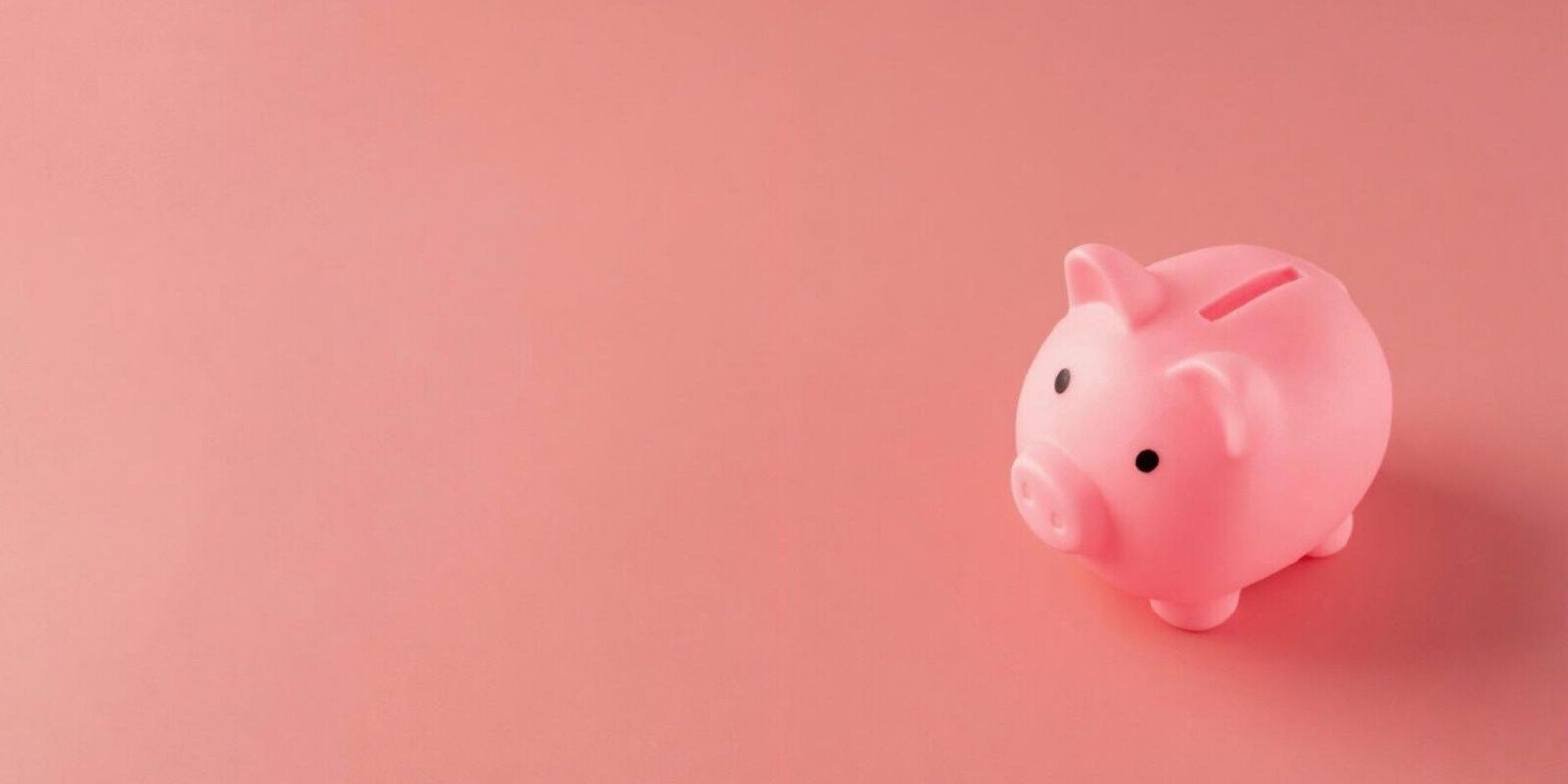  The image depicts a pink piggy bank set against a soft pink background, symbolizing savings or financial management.